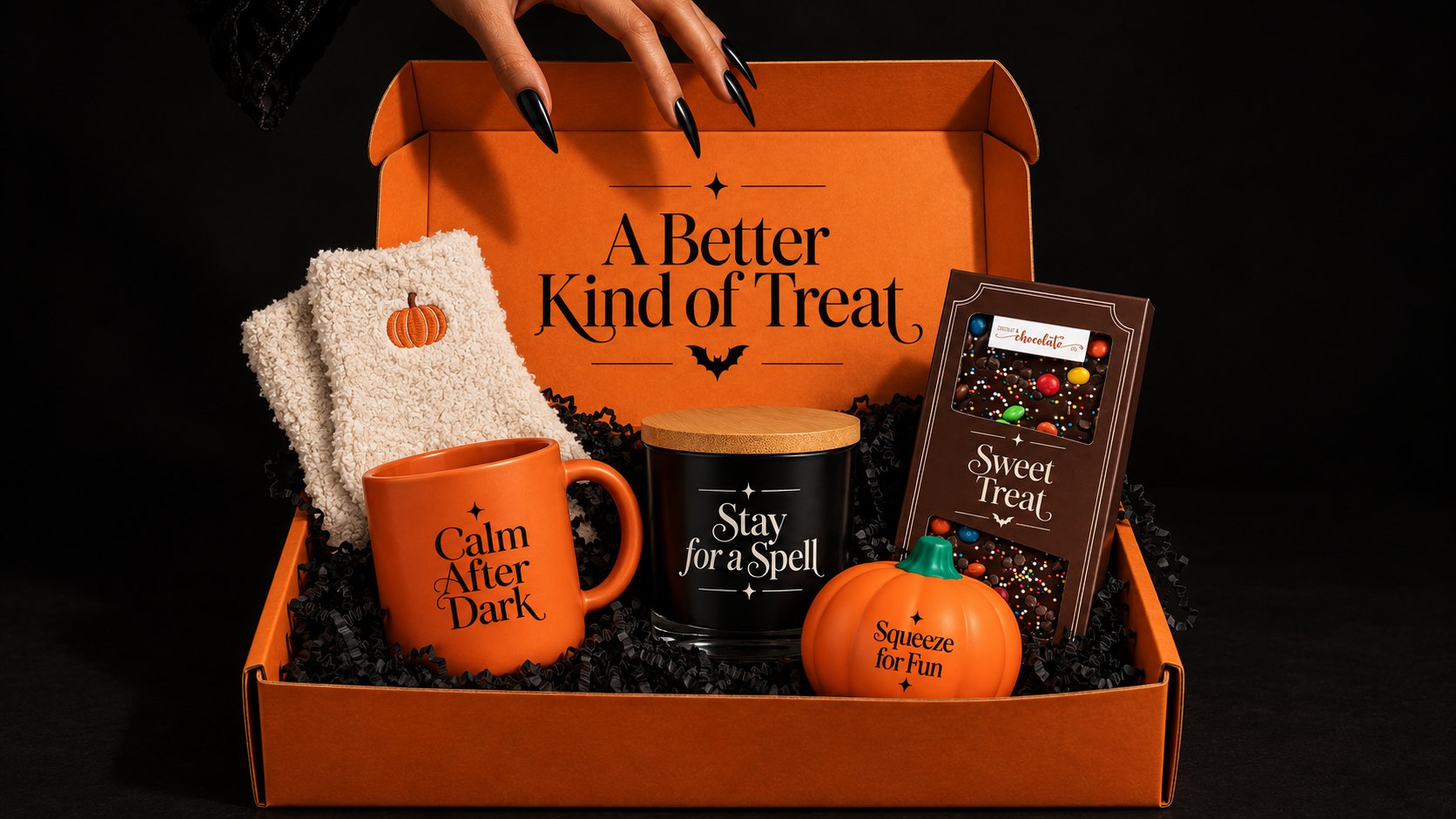 The Halloween appreciation box packed with pumpkin fuzzy socks, a Calm After Dark mug, a Stay for a Spell candle, a Sweet Treat chocolate bar and a Squeeze for Fun pumpkin
