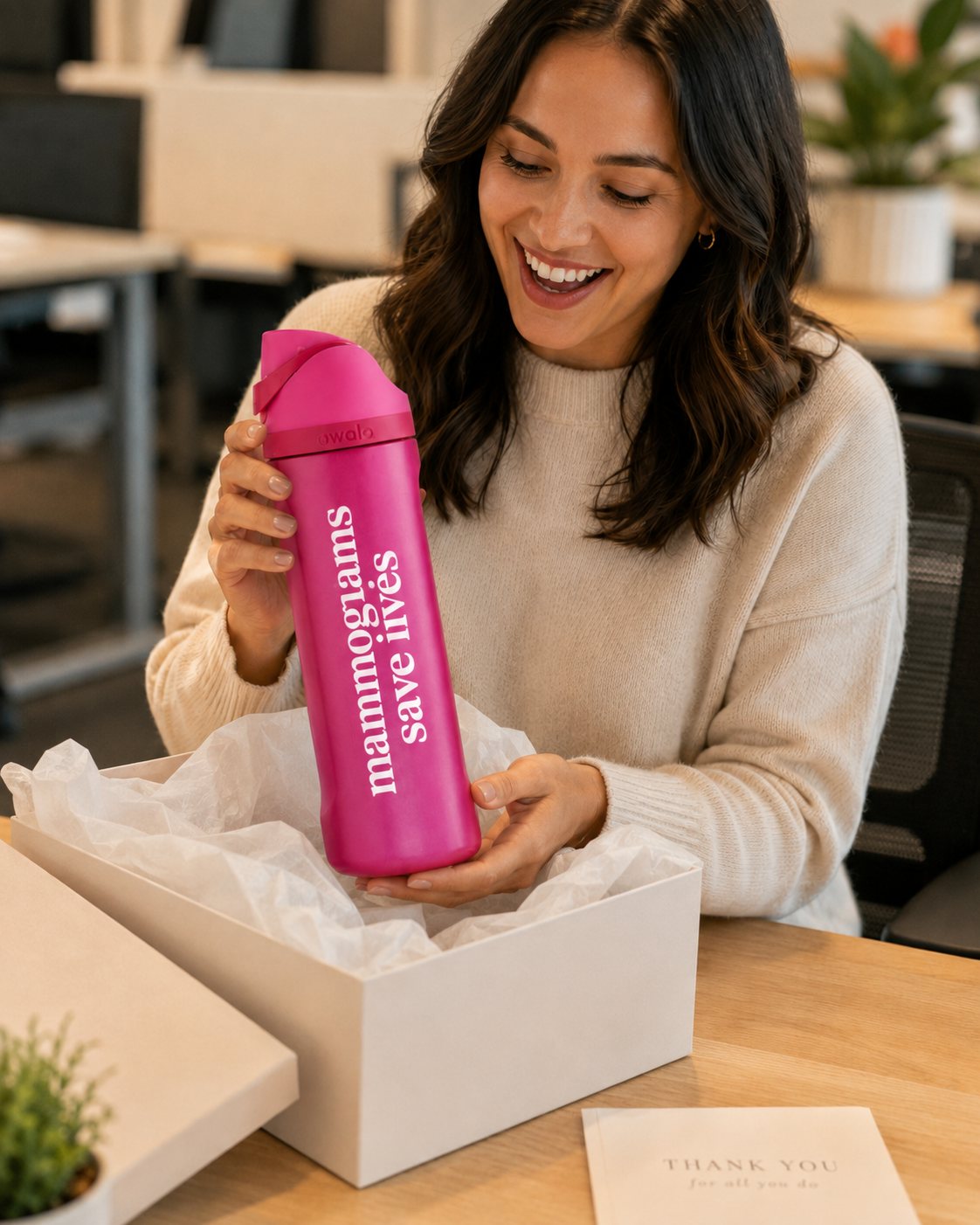 Staff member unboxing a recognition gift bottle